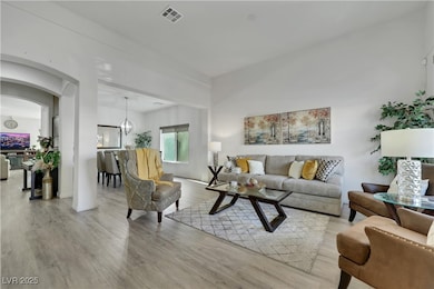 Living room with wood finished floors and arched w