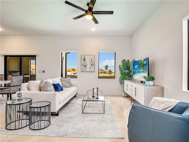 Living area featuring a ceiling fan and recessed l