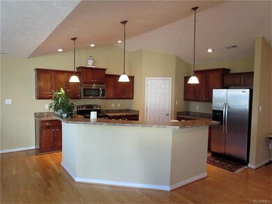 Open kitchen featuring vaulted ceilings, abundant 