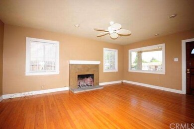 Gleaming hardwood floors and fireplace add to the 