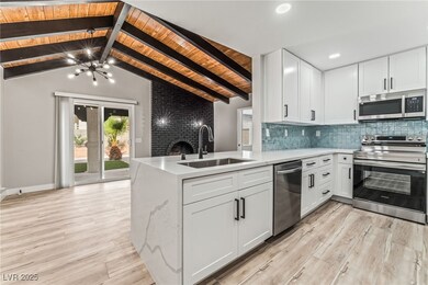 Kitchen with tasteful backsplash, light wood-type