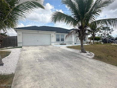 Single story home with stucco siding, driveway, an