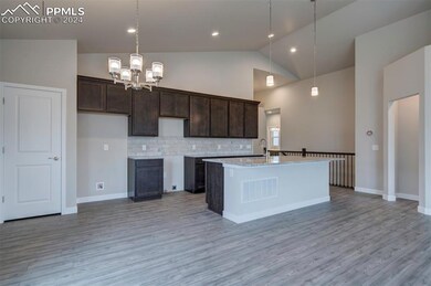 Kitchen with high vaulted ceiling, backsplash, a c