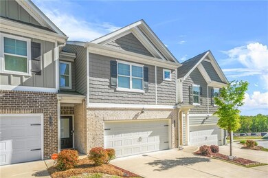 Townhome / multi-family property featuring an atta