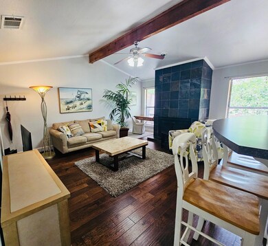 Living area featuring visible vents, wood-type fl