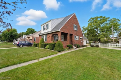 View of front of house featuring brick siding, a porch, and roof with shingles