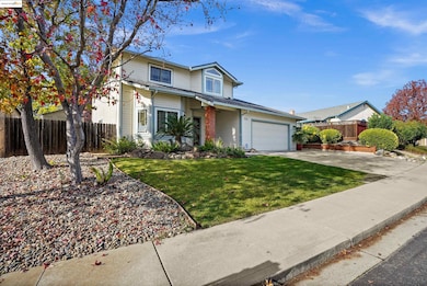 Traditional home with driveway, brick siding, and a garage
