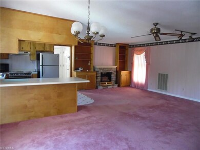 Living/Dining with fireplace and built-in shelves.