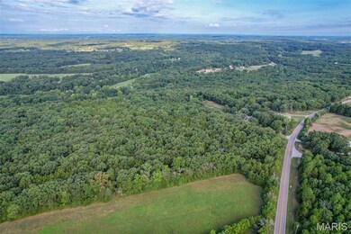 Aerial view of property's location featuring a heavily wooded area