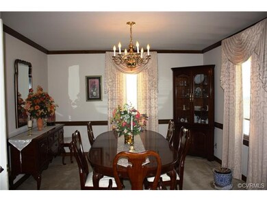 Formal dining room with crown moulding, chair rail
