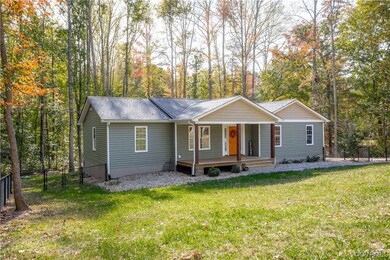 Ranch-style home with covered porch and a front la