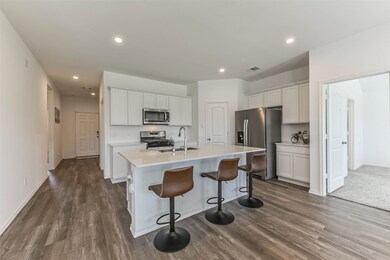 Spacious kitchen with stainless steel appliances, large corner pantry with large island and breakfast bar.