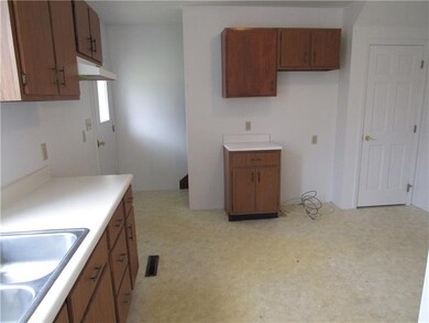 Eat in Kitchen with white walls, neutral flooring.