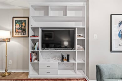Details featuring baseboards and wood finished flo