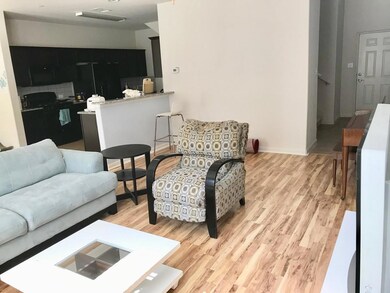 Living area with baseboards and light wood-style 
