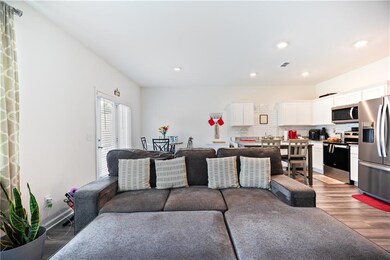 Living room with wood finished floors and recessed lighting