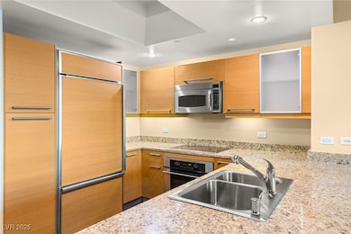 Built-in refrigerator, stainless steel appliances, and sleek countertops.