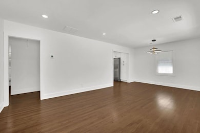 Unfurnished room with recessed lighting and dark wood-type flooring