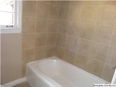 Beautiful tile surrounds the tub/shower combo in t
