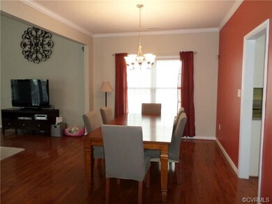 Formal dining room with crown molding and hardwood