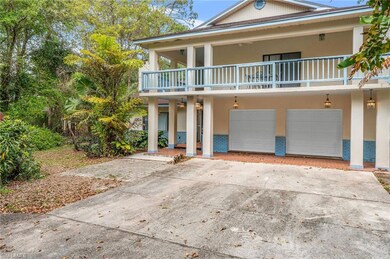 Coastal inspired home with brick siding, a garage,