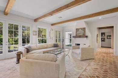 Additional keeping room view. Doors open up to backyard and patio. Gorgeous durable brick floor.