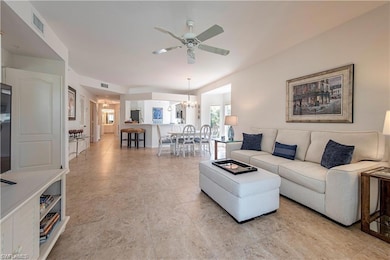Living room with ceiling fan with notable chandeli