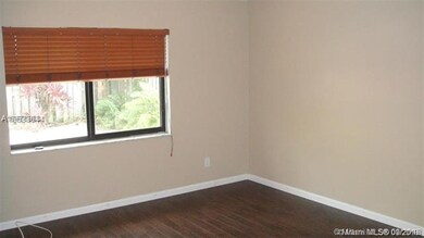 MASTER BEDROOM w/ WOOD FLOORING OVERLOOKING POOL A