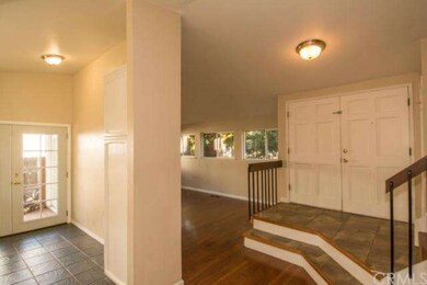 Entry way, living room and portion of the kitchen