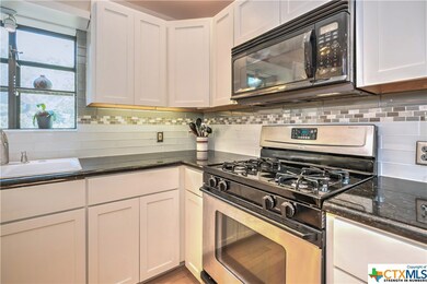 Lovely granite counters, built-in microwave and 4-