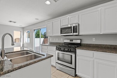 Kitchen with stainless steel appliances, a sink, w