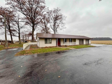 View of front of property with driveway, a garage, a metal roof, and a front lawn