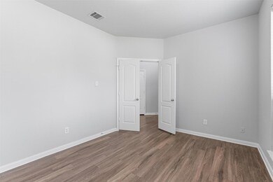 Empty room featuring wood finished floors and bas