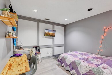 This is a cozy bedroom featuring modern recessed l