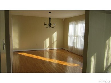 Formal dining area has hardwood floors and faces t