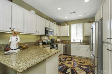 Upgraded kitchen features granite countertops and 