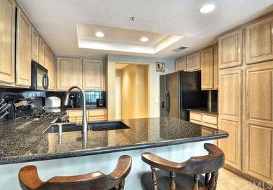 THE KITCHEN HAS GLOSSY COUNTERTOPS AND FULL BACKSP