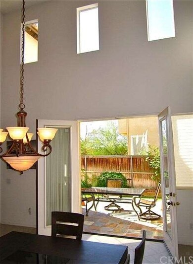 French doors open to tiled courtyard
