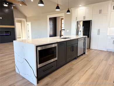 Huge island with microwave, trash, and dishwasher