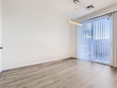 Empty room featuring visible vents, light wood-sty