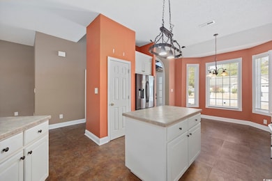 Kitchen featuring pendant lighting, white cabinetr