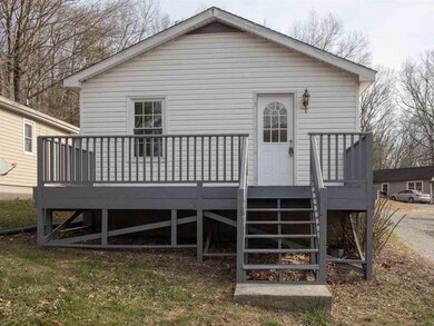 The front view of the home features a spacious dec