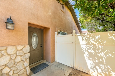 Doorway to property with a gate and stucco siding
