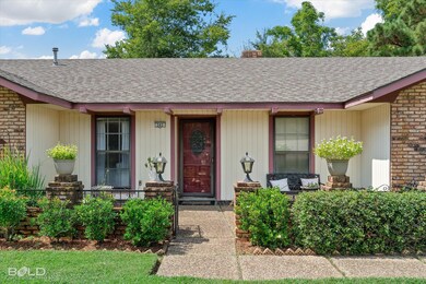 Doorway to property featuring a shingled roof, a chimney, and covered porch