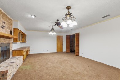 Unfurnished living room with a brick fireplace, a