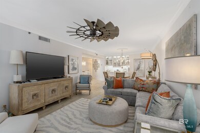 Living room featuring wood-type flooring and ceiling fan with notable chandelier