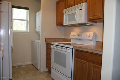 Kitchen w/Stackable Washer & Dryer
