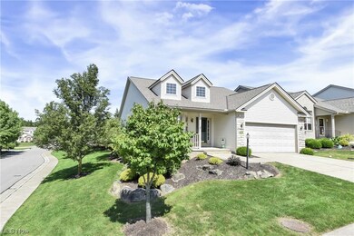 View of front of property with garage and a front lawn