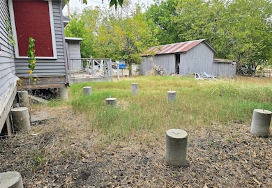 View of yard featuring an outbuilding and view of scattered trees