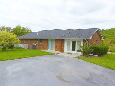 Rear with large paved parking area